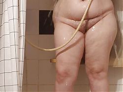 Fat bbw milf takes a shower while she dances and soaps her big boobs.